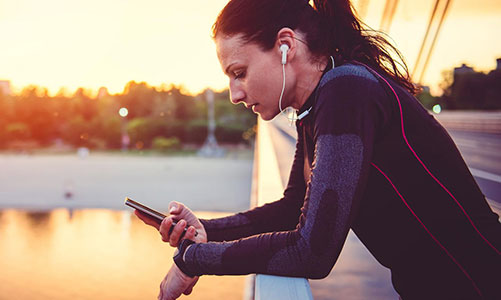 woman on bridge with mobile