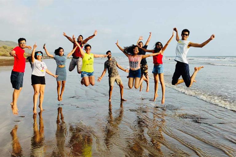 team jumping on beach