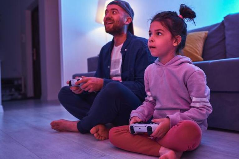 dad and daughter with devices