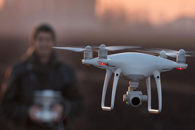 man flying drone