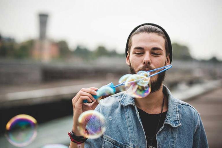 man blowing bubbles