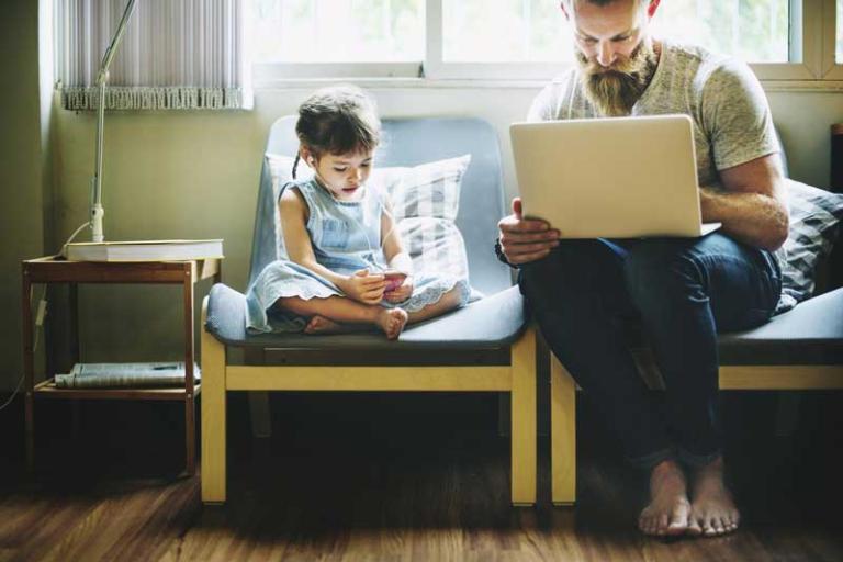 man and girl using devices