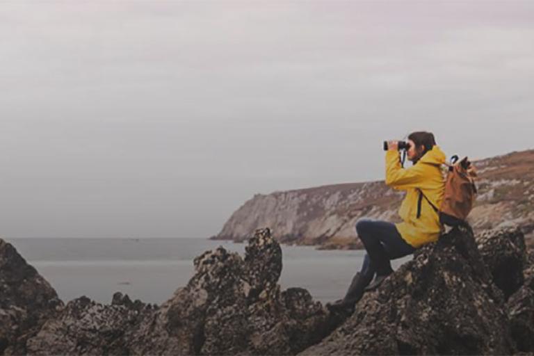 woman looking through binoculars