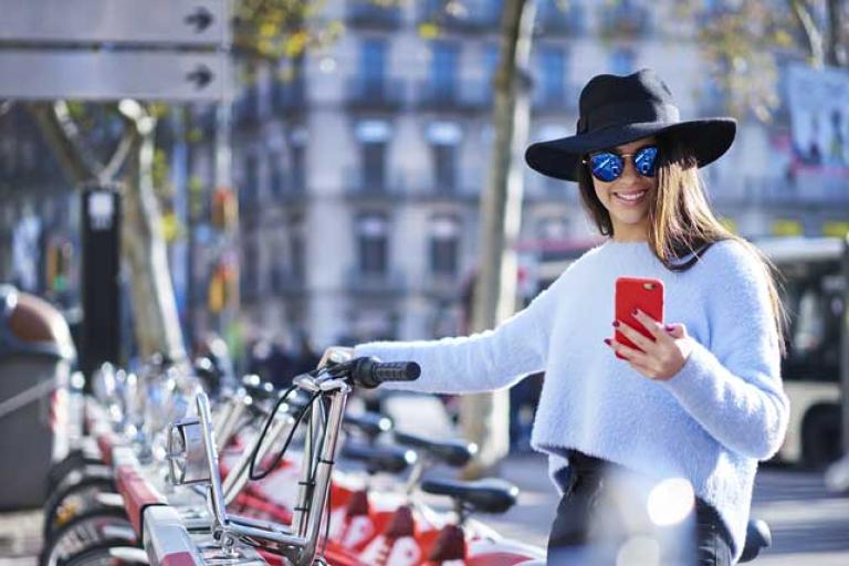 woman with bicyle and mobile