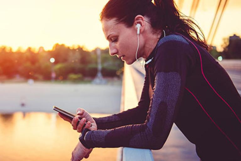 woman on bridge with mobile