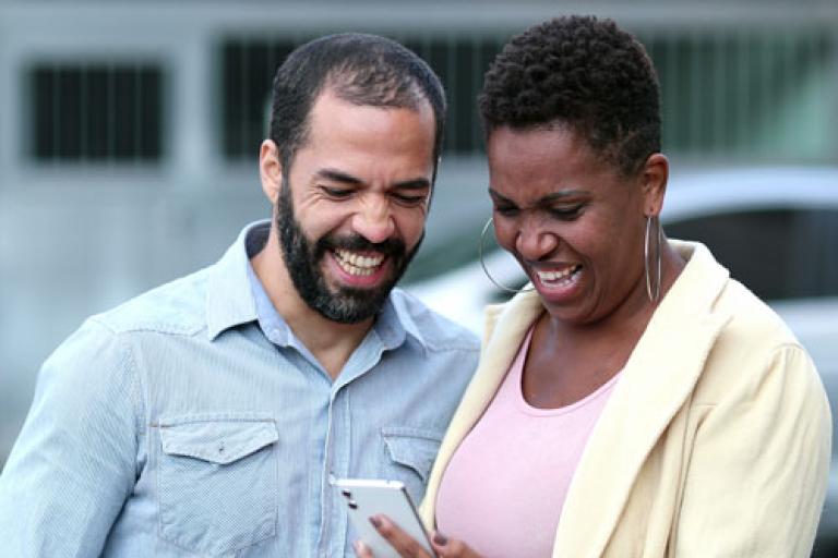 man and woman watching video