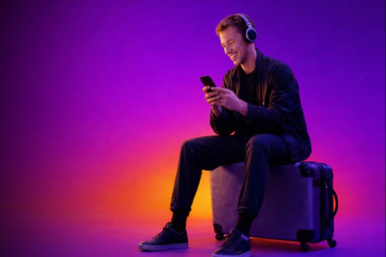 man-headphones-suitcase-purple